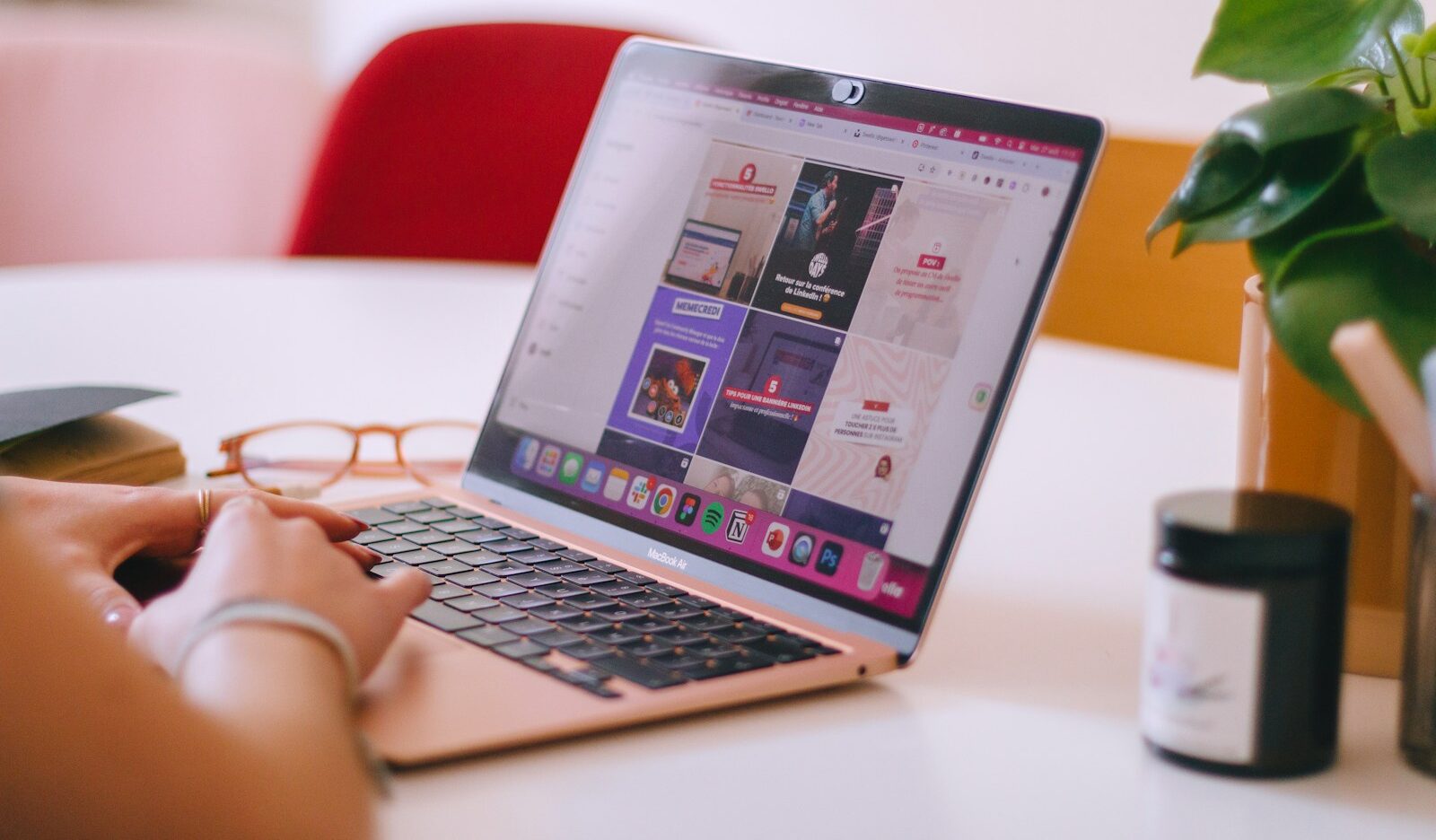 A woman sitting at a table using a laptop computer